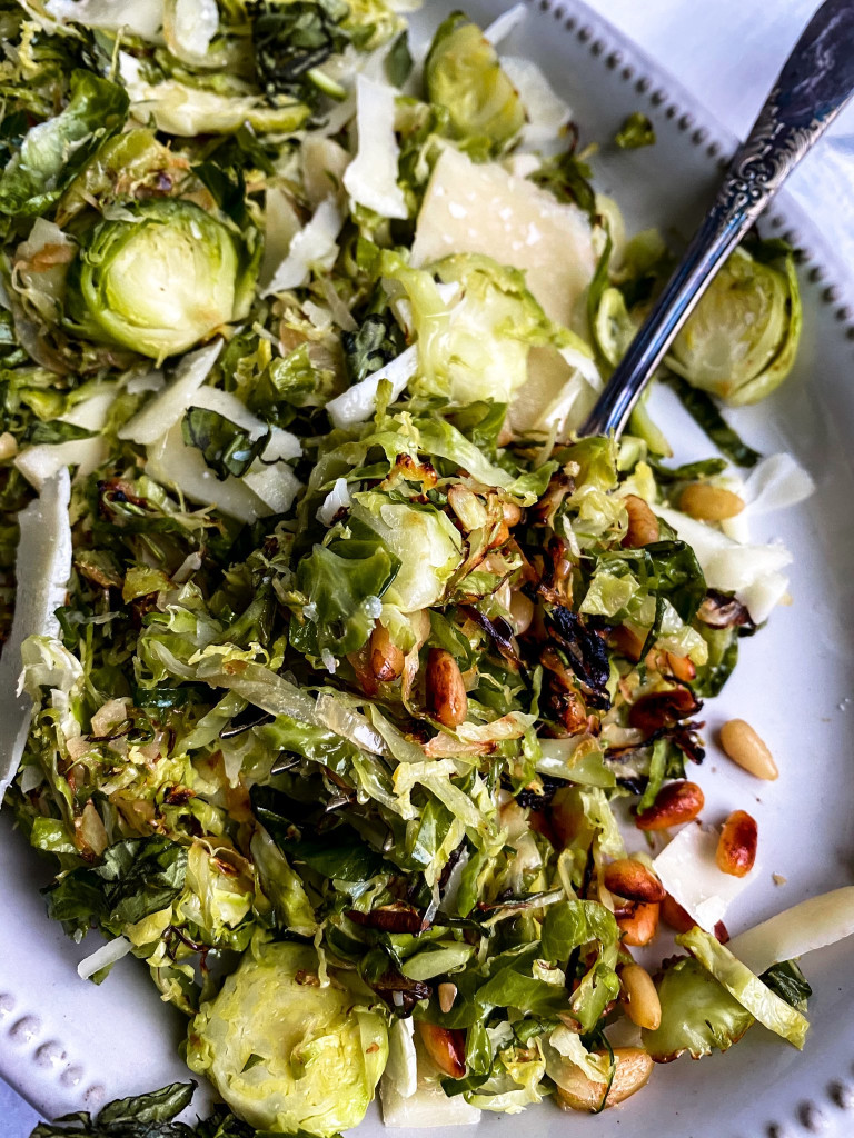 45 degree close up of fork dishing out roasted brussel sprout salad