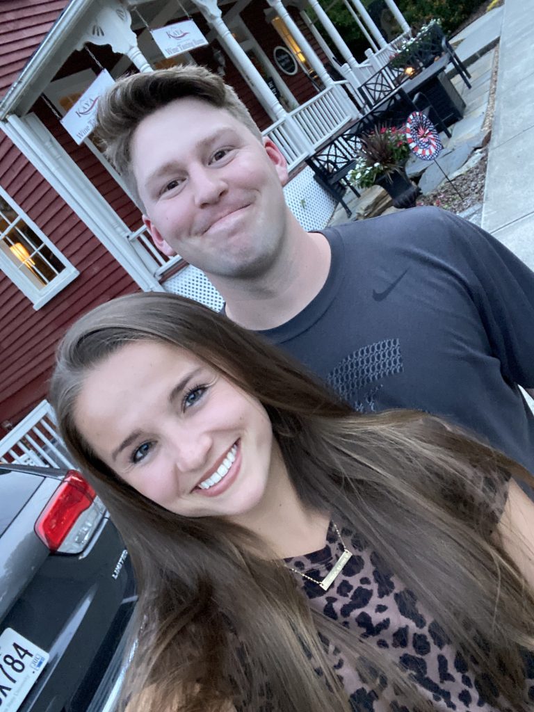 couple taking a selfie smiling together outside