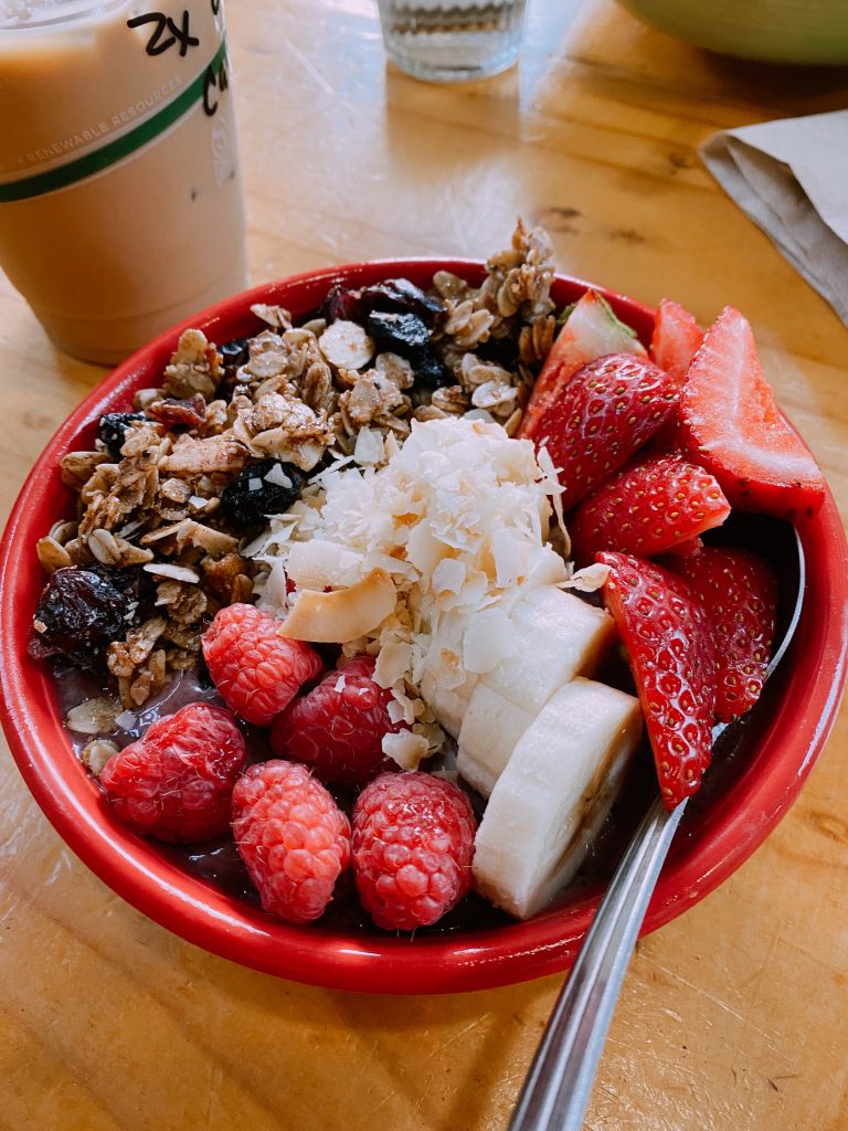 fruit bowl with strawberries, banana, and granola
