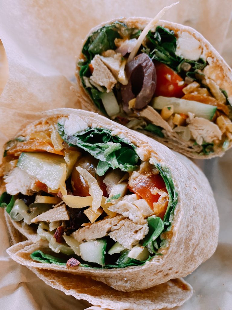 greek wrap loaded with veggies and half ate
