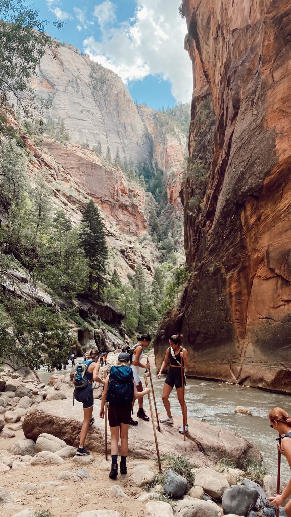 action shot of six girls hiking in The Narrows