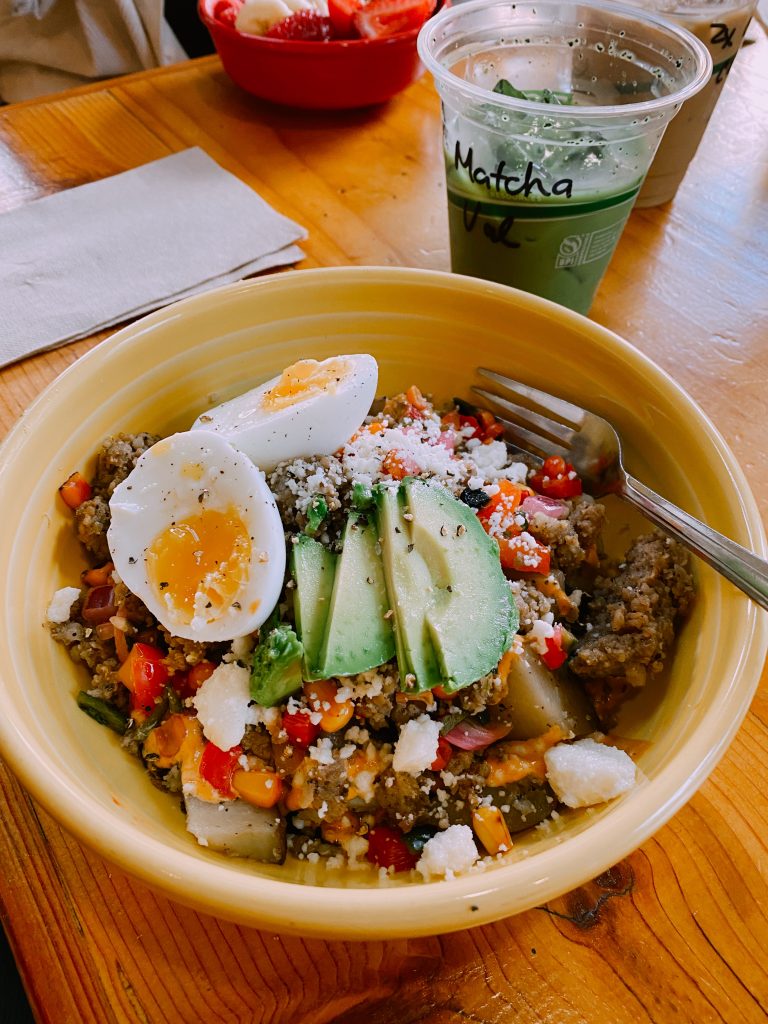 yellow bowl with quinoa, avocado, and eggs