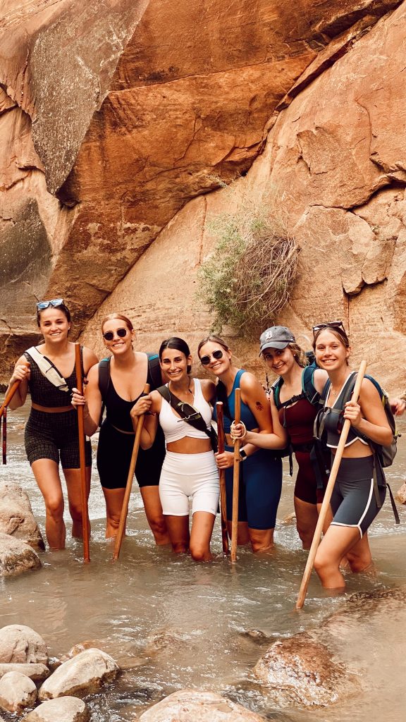 smiling bunch of six ladies in the middle of the Narrows Hike