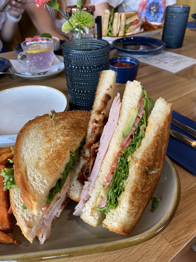 double stacked turkey bacon avocado club sandwich on a plate
