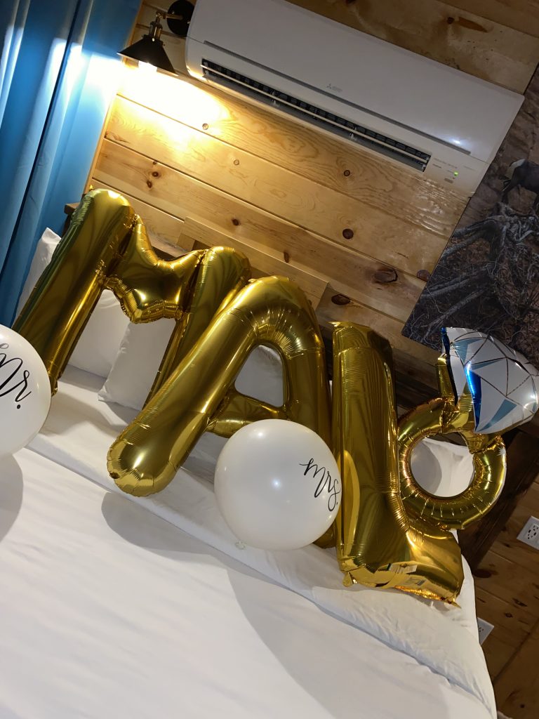 large gold balloons spelling out the bride's name in the Yurt
