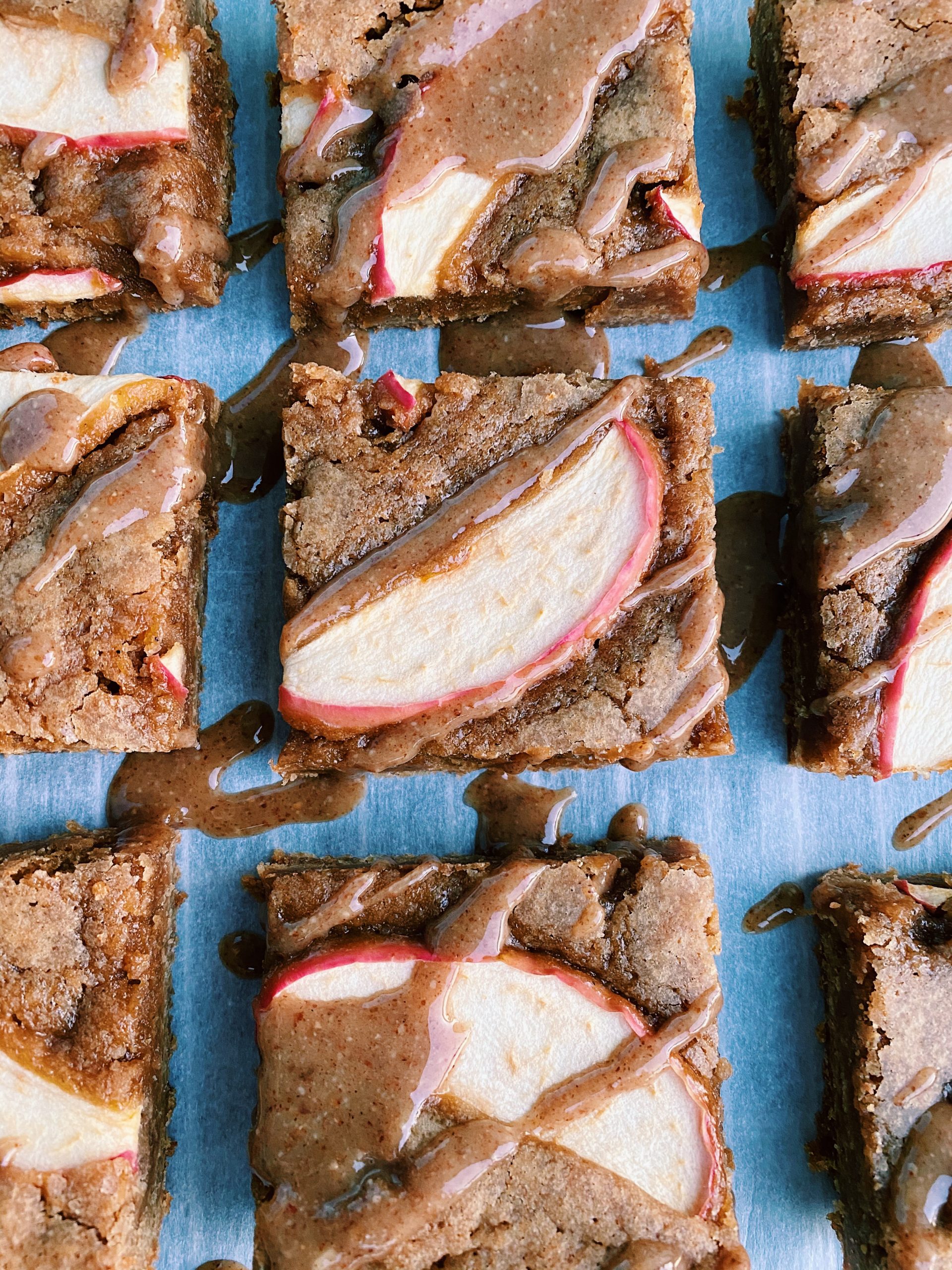 Apple Cinnamon bars cut into squares and drizzled with caramel sauce.