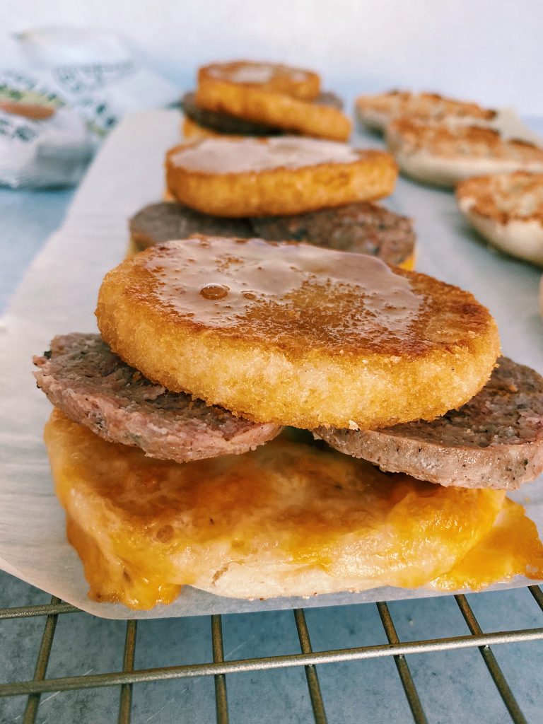 Close up image of partially assembled breakfast sandwiches with grey background