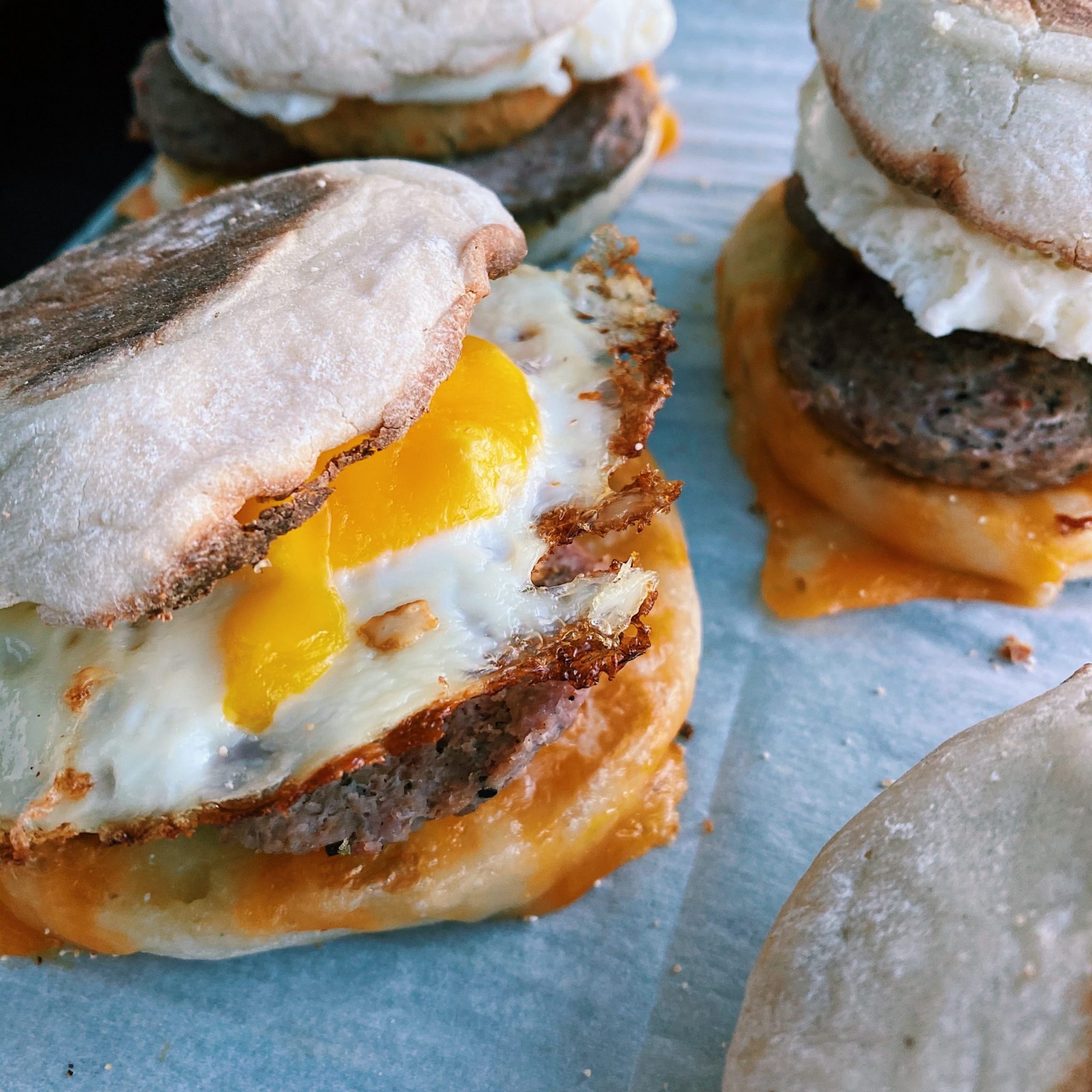 Showcasing image of stacked breakfast sandwich, especially the crispy fried egg edges