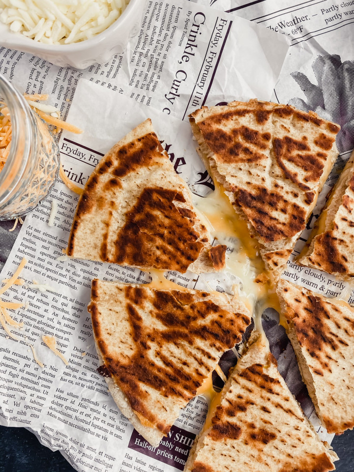 healthy cheese quesadilla sliced into six pieces with melty cheese oozing out.