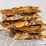 Macro-friendly cheesy quesadilla slices are stacked on top of one another.