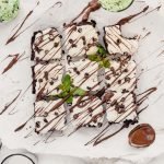Mint Brownies with Cream Cheese Frosting drizzled with chocolate and topped with mint leaves
