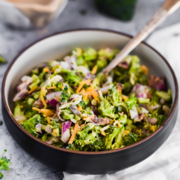 Healthy Broccoli Salad in a black bowl with a fork