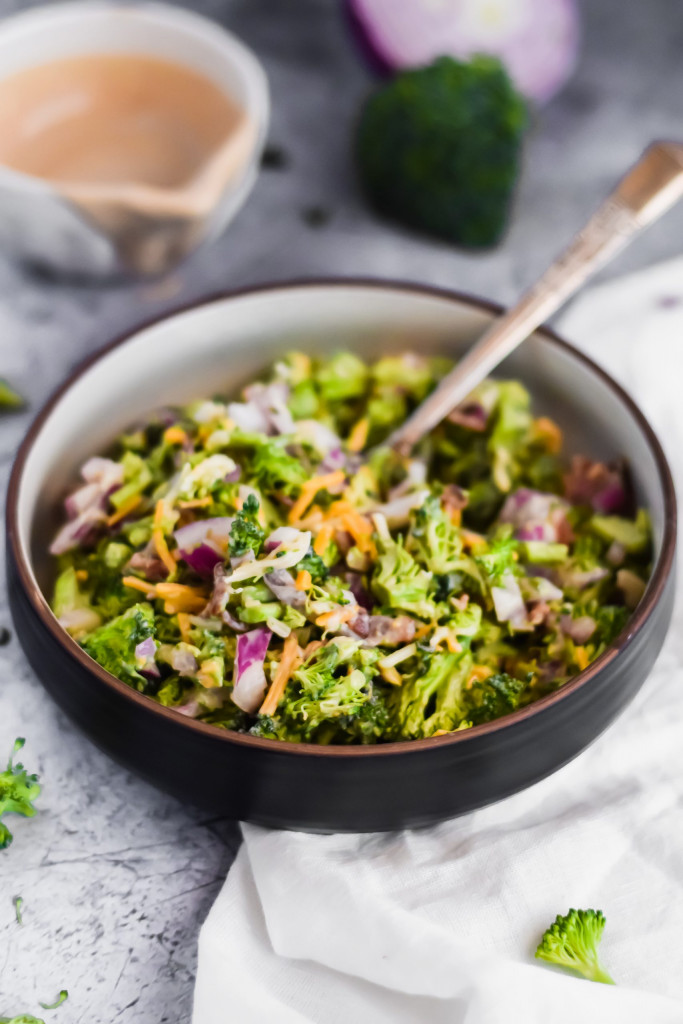 Healthy Broccoli Salad in a black bowl with a fork