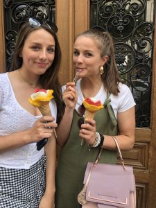 two girls enjoying flower gelato on the street