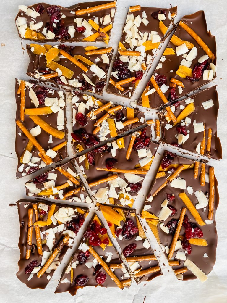 Cracked chocolate bark with pretzels, dried fruit, and coconut shavings