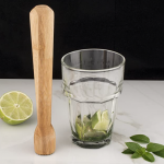 wooden drink muddler with glass and lime