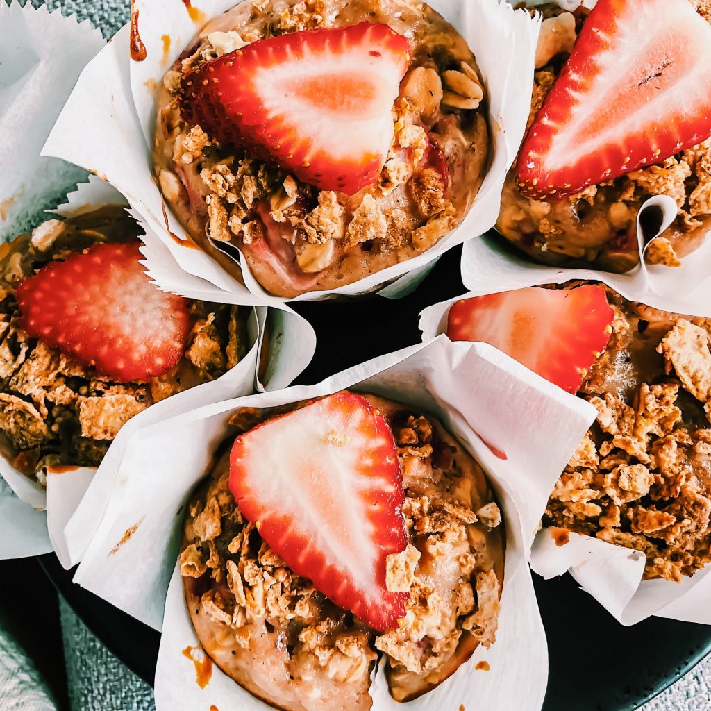 cluster of muffins grouped together and topped with Strawberries
