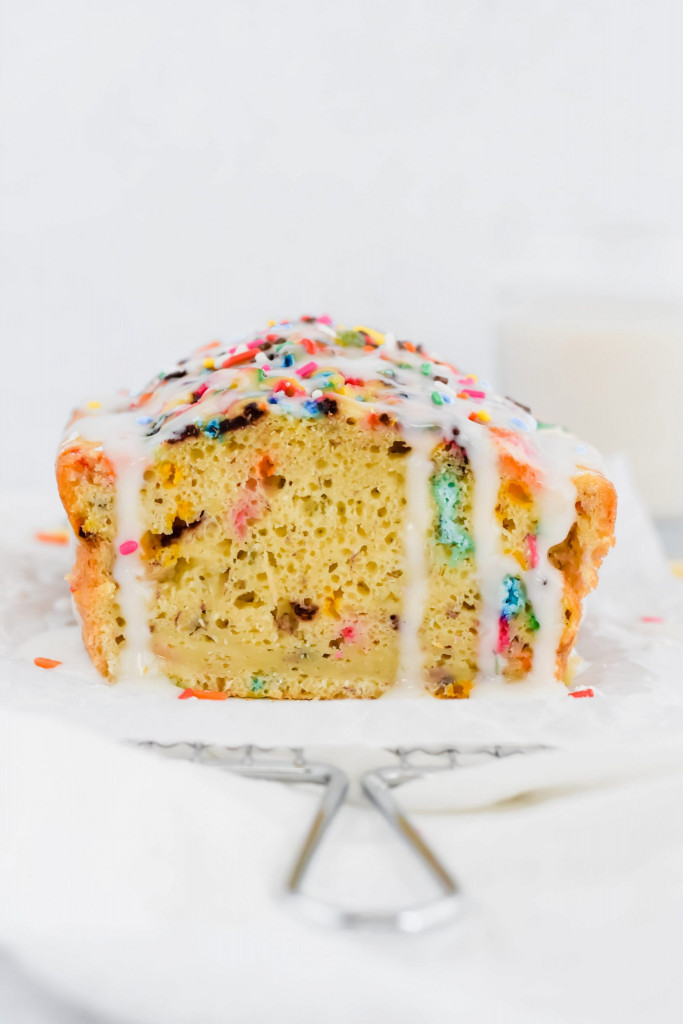 90 degree image of funfetti pancake loaf bread drizzled with glaze and extra sprinkles