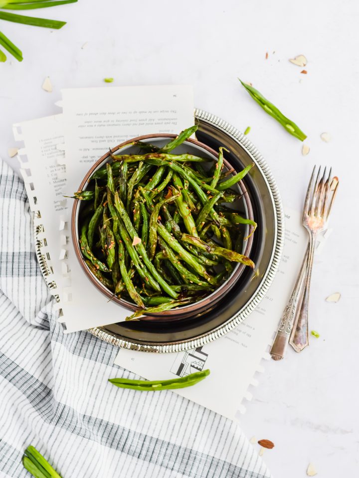 black bowl filled with balsamic green beans.