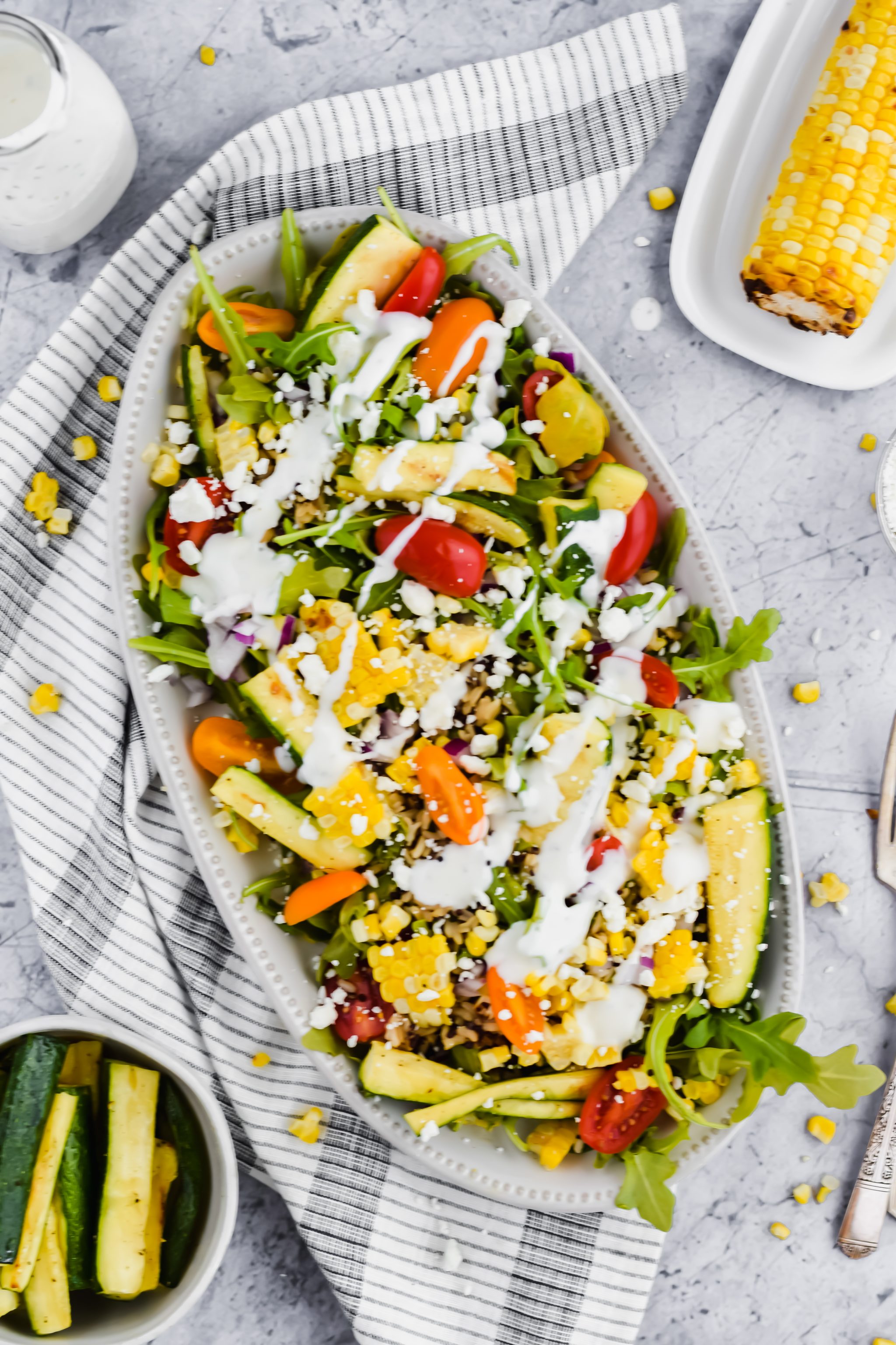grilled veggie salad fully assembled with dressing drizzled on top.