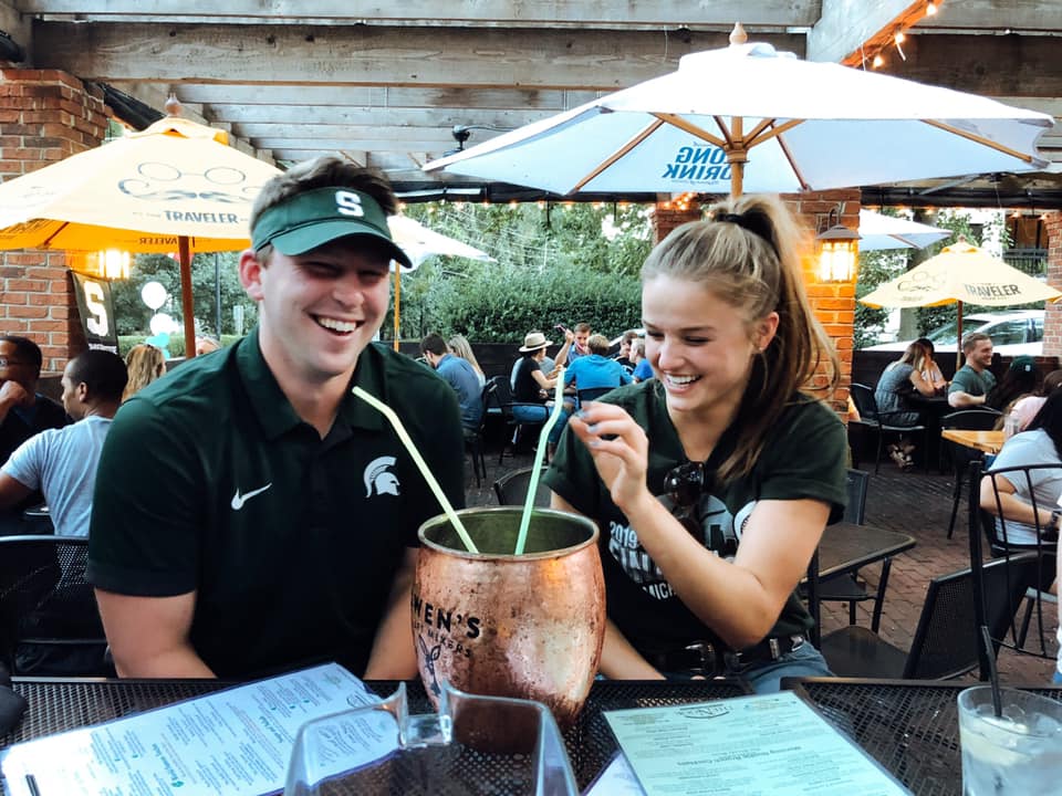 boy and girl sitting sharing a 160oz moscow mule