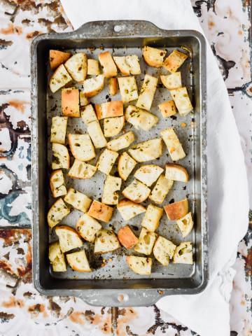 oven roasted homemade french bread croutons with Italian seasoning on metal pan.
