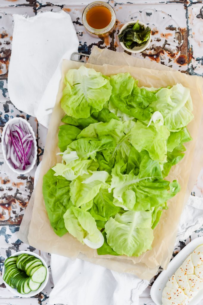 bed of butter lettuce on rectangular platter ready to be assembled with other ingredients