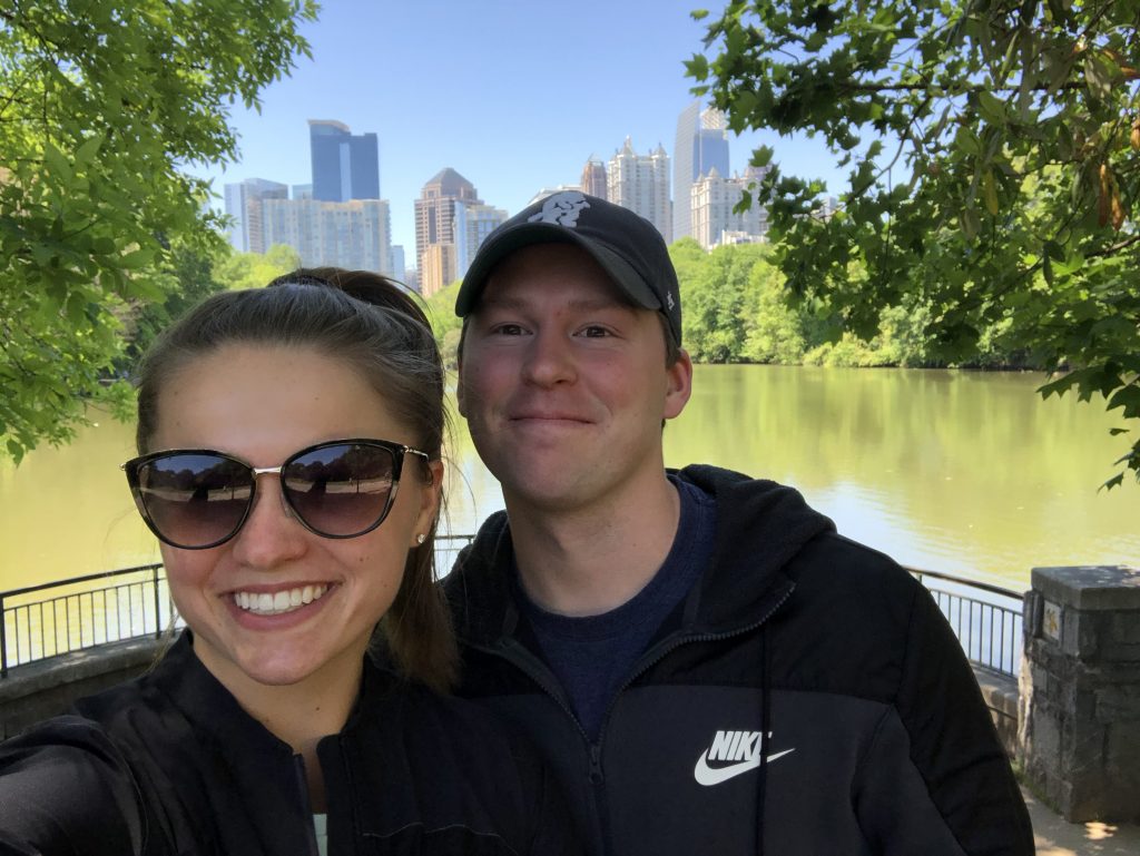 couple smiling in front of cityscape