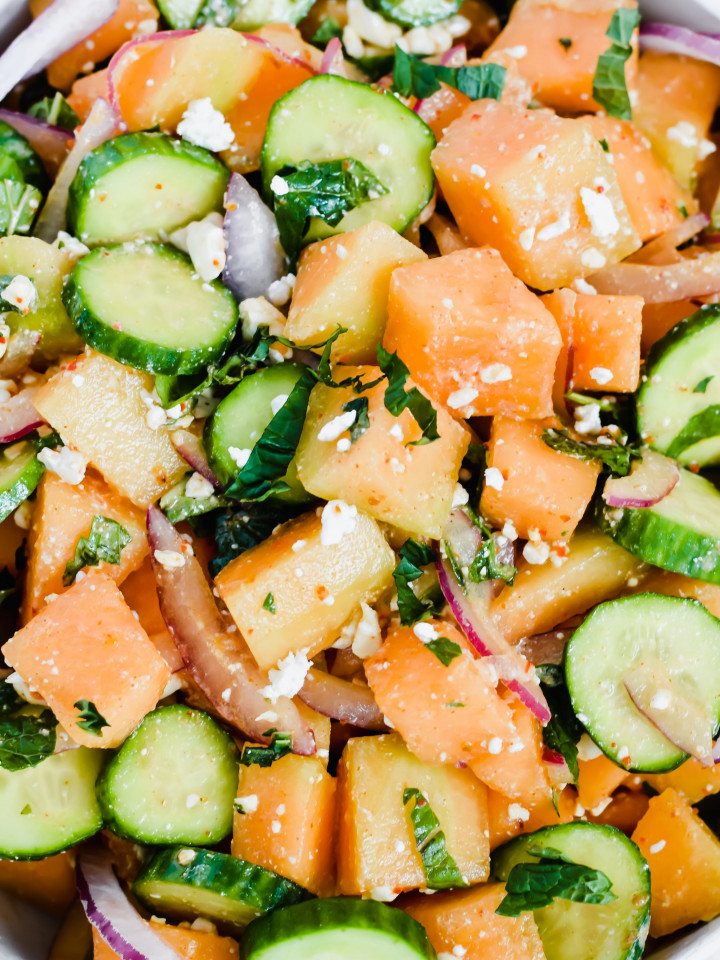 close up image of cantaloupe cucumber feta mint salad all tossed together.
