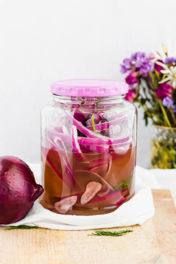 mason jar capped and filled with red pickled onions and jalapenos