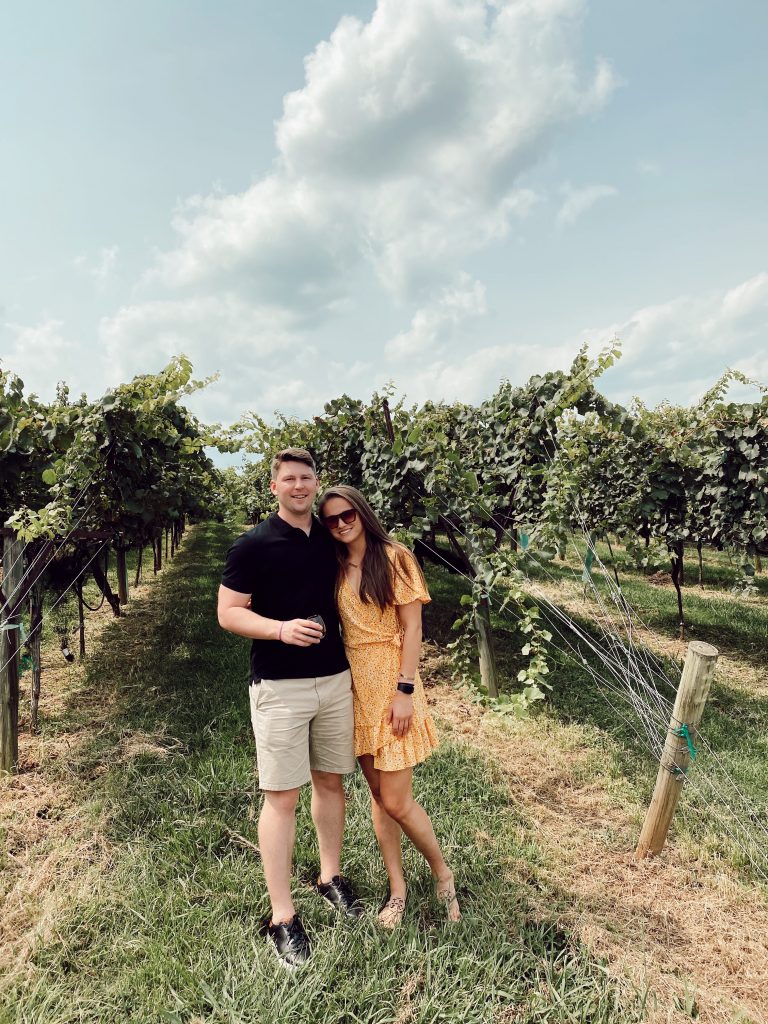 couple smiling together in the vineyard