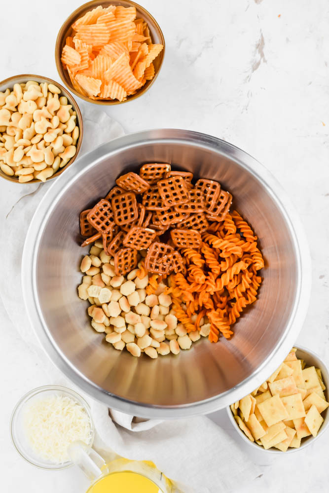 pretzels, fritos, and oyster crackers in mixing bowl