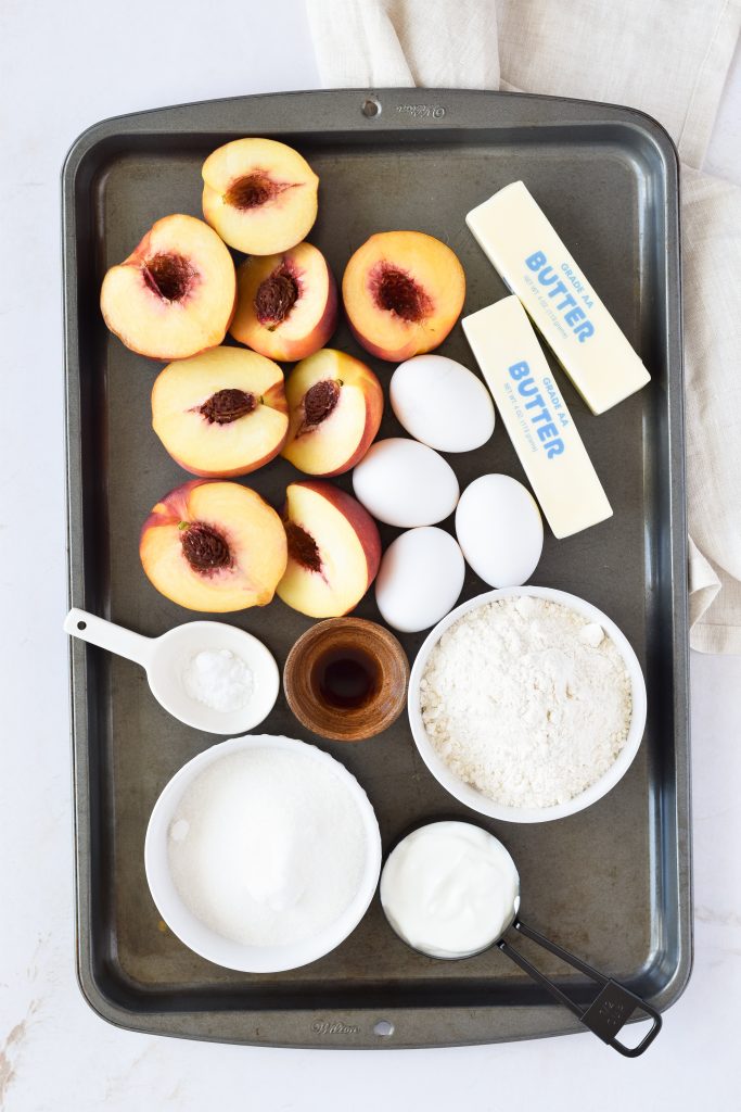 metal sheet pan with all ingredients for Peach Bundt Pound Cake in separate bowls