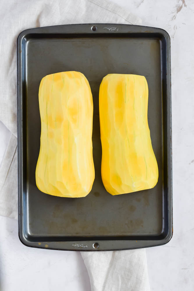 butternut squash peeled and halved on sheet pan