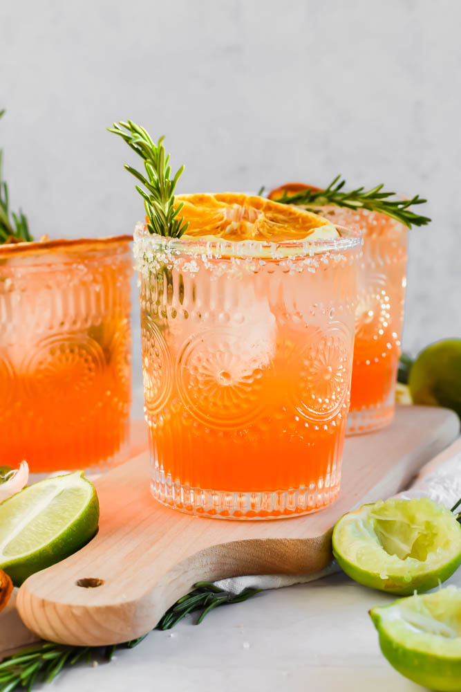garnished Italian Margaritas with fresh rosemary and dried oranges