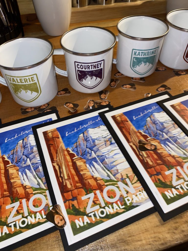 zion prints and campfire mugs displayed on a table