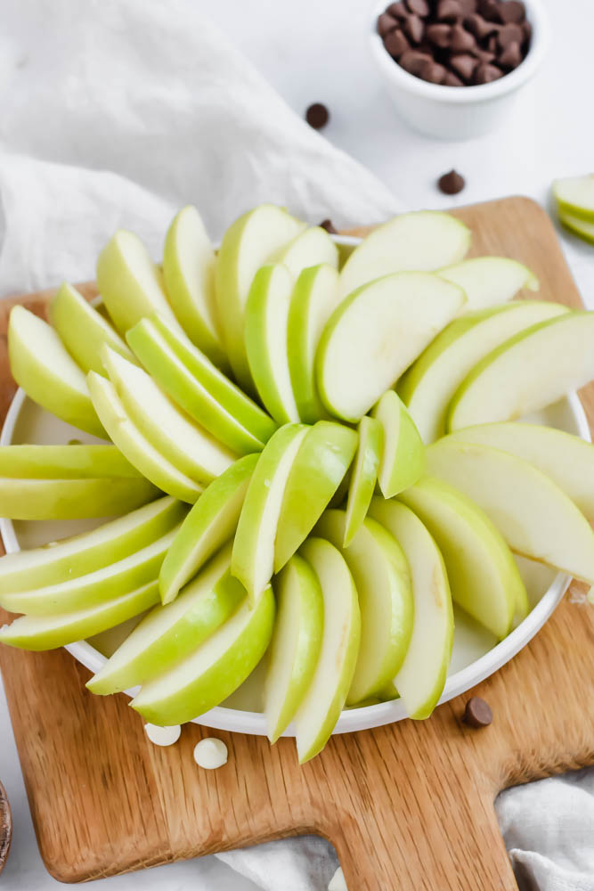 diced green apples displayed in a circular formation on white plate