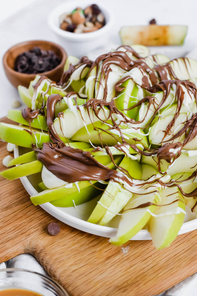 melted milk chocolate drizzled on top of green apples