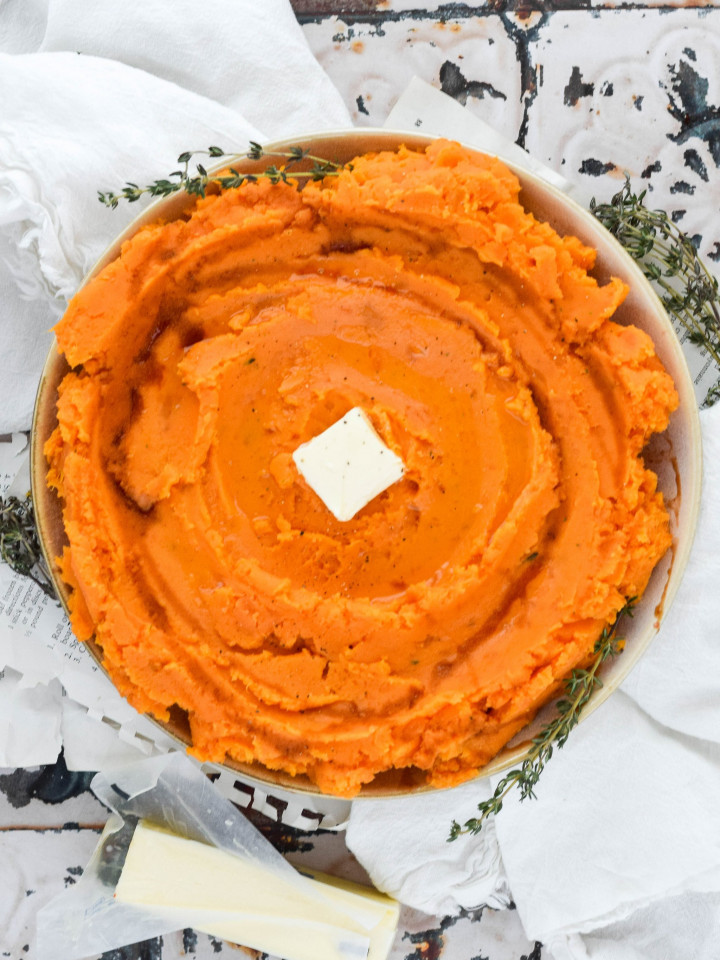 savory mashed sweet potatoes topped with pat of butter.