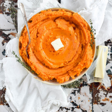 overhead view of savory mashed sweet potatoes topped with butter