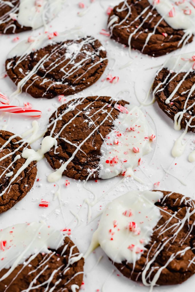 overhead shot of white chocolate dipped peppermint cookies on white backdrop