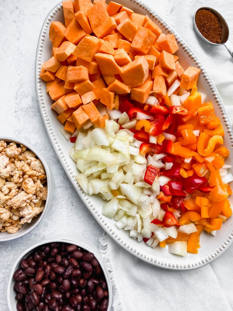 platter with diced sweet potatoes, onions, peppers, and beans