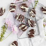 Copycat Reese's Easter Eggs drizzled with white chocolate on a metal wire serving tray