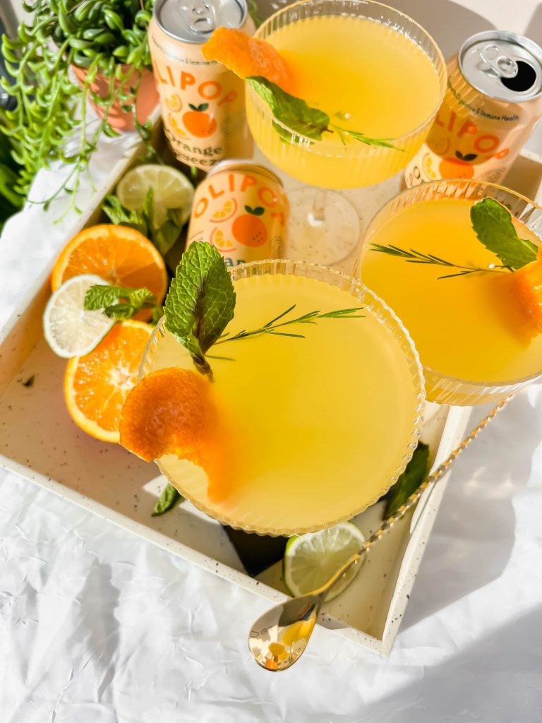 close up of Bahama Mama cocktail garnished with orange peels and mint