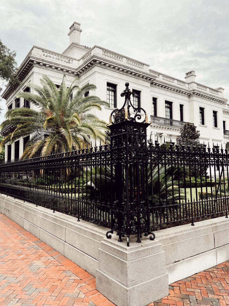 large white house in Savannah, Georgia with black metal gates in front of it