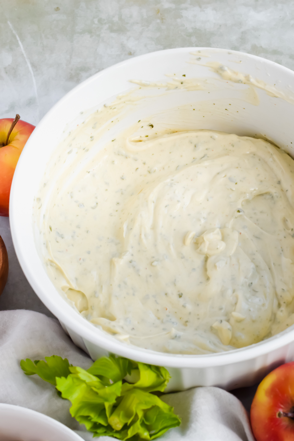 dressing for healthy pesto chicken salad in white bowl.