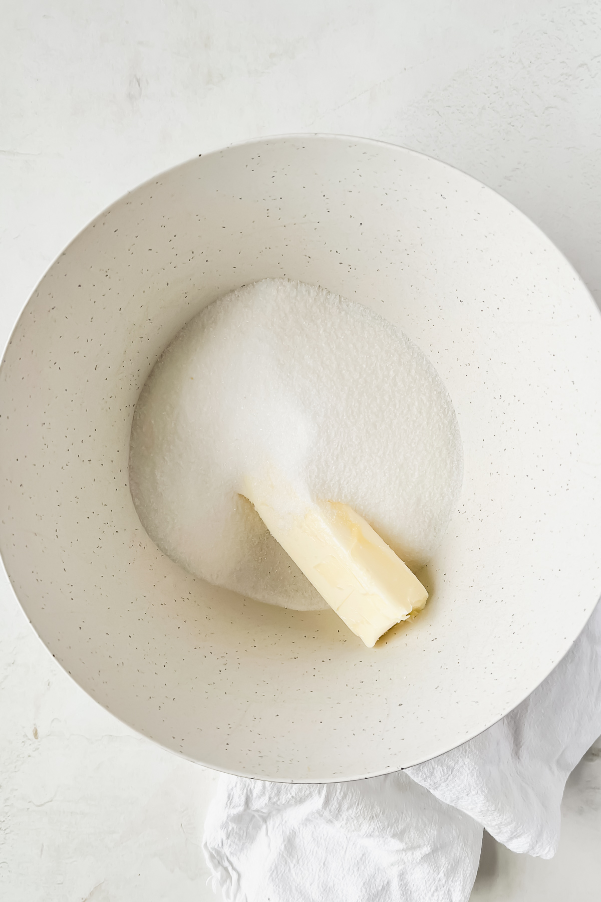 butter and sugar in white mixing bowl.