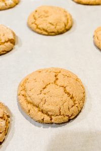 peanut butter crinkle cookies baked on silver baking tray.