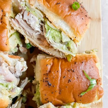 rotisserie chicken hawaiian sliders on wood cutting board.