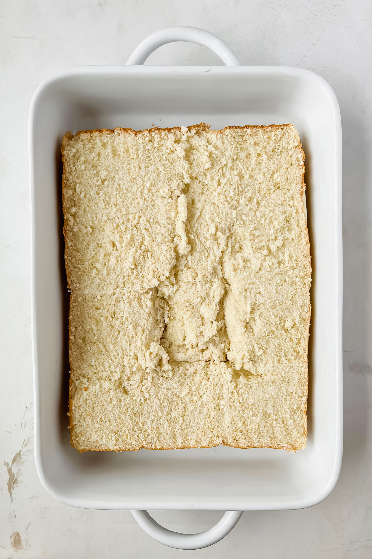 bottom hawaiian slider bun in white baking dish.
